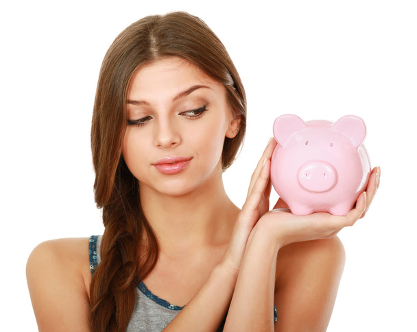 Woman standing with piggy bank - Фото, изображение
