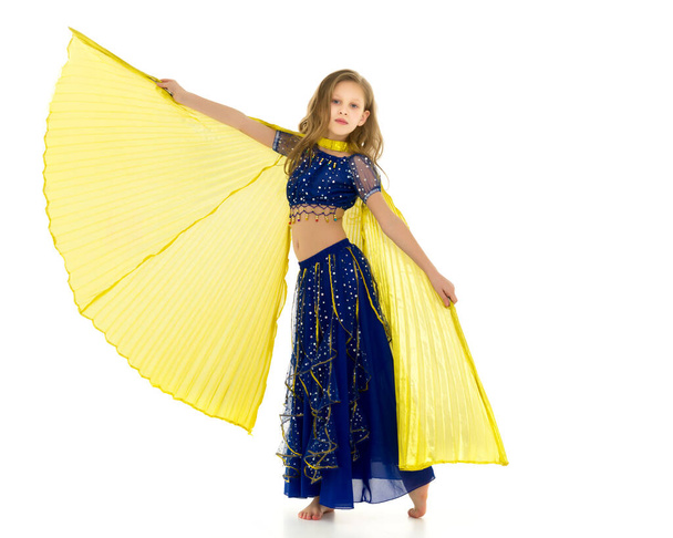 Blonde Girl in Oriental Costume Dancing Belly Dance with Wings - Foto, imagen