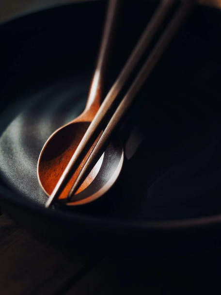 Wooden spoon, chopsticks and porcelain plate - Fotoğraf, Görsel
