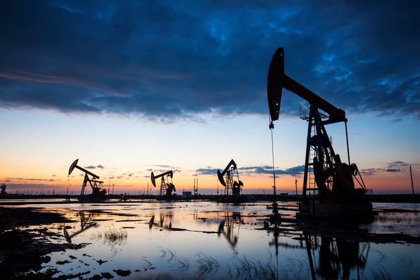 Místo těžby ropy, ve večerních hodinách jsou v provozu olejová čerpadla - Fotografie, Obrázek