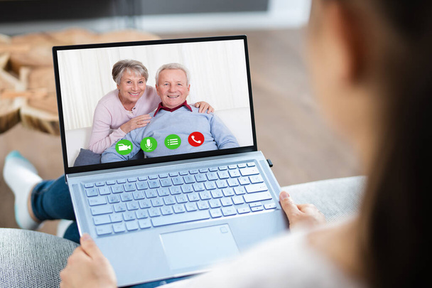 Woman Video Chat On Computer Laptop With Parents - 写真・画像