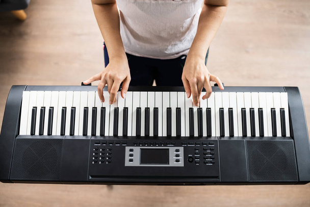 Woman Playing Music Keyboard Piano Instrument At Home - Foto, imagen