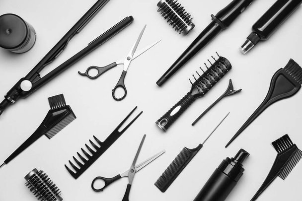 Set of hairdresser's tools on grey background - Foto, afbeelding