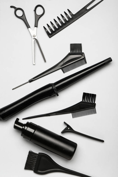 Set of hairdresser's tools on grey background - Photo, Image