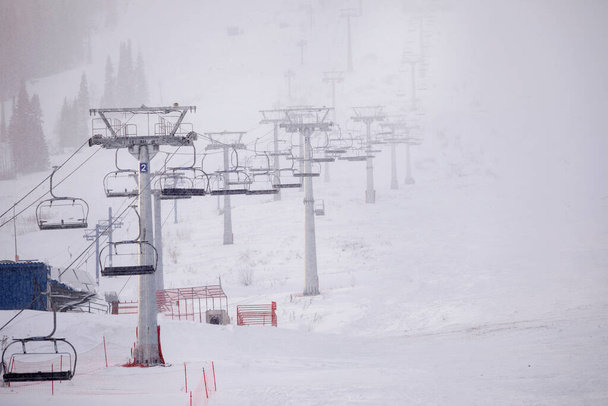 Cable car with cabins on a snowy day at a mountain resort. Selective focus, blurred background. 14/11/2020 Sheregesh, Russia - Photo, image