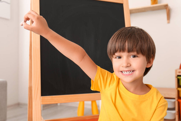 Happy little boy with chalk in kindergarten - Фото, зображення