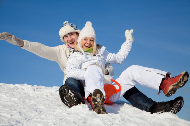 young couple having fun winter time in ski resort - Foto, imagen