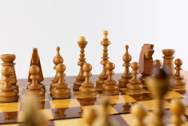 a chessboard made of wooden pieces on white - Photo, Image