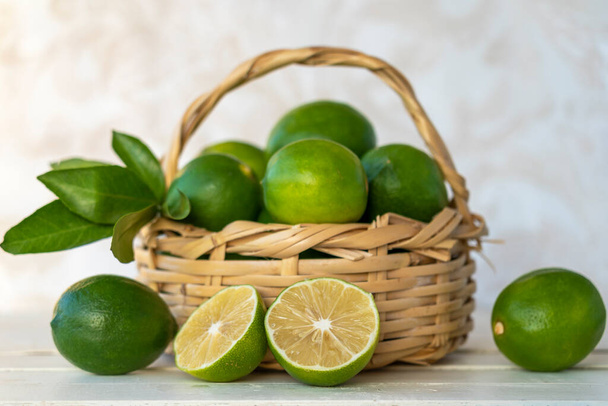 fresh limes with leaves in basket - Photo, Image