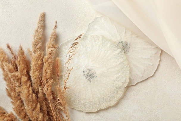 Epoxy resin, fabric and field flowers on white background - Photo, Image