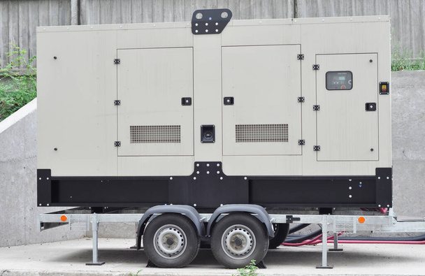 A close-up of a quiet towable, standalone emergency gaseous generator. A mobile trailer mounted natural gas generator is providing transportable power to the construction, industrial applications. - Photo, Image