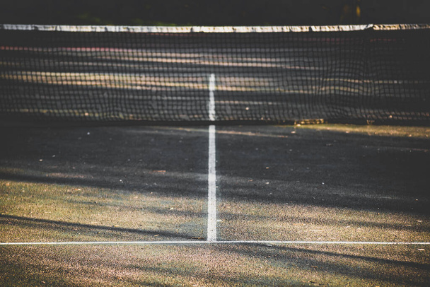 A selective focus shot of a tennis court under the sunlight - Photo, Image