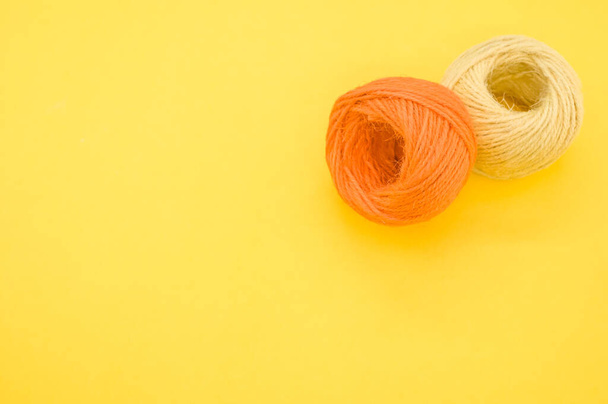 The yarn balls for knitting isolated on yellow background - Φωτογραφία, εικόνα
