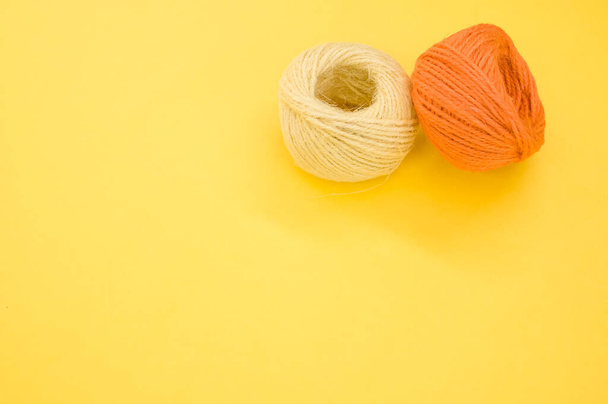 The yarn balls for knitting isolated on yellow background - Fotografie, Obrázek