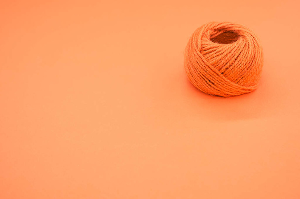 An orange yarn ball for knitting isolated on orange background - Fotoğraf, Görsel