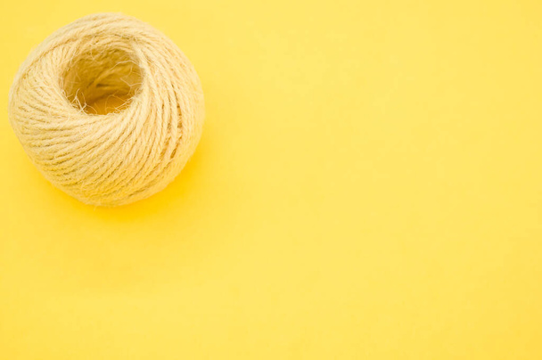 A yarn ball for knitting isolated on yellow background - Φωτογραφία, εικόνα