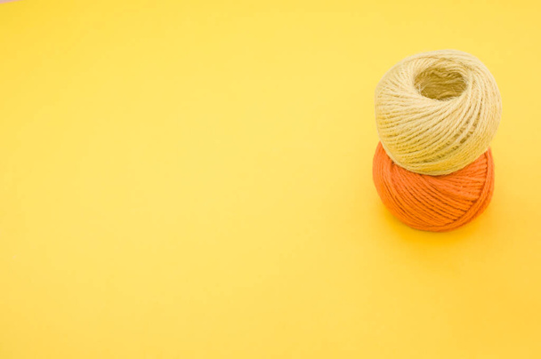 The yarn balls for knitting isolated on yellow background - Photo, image