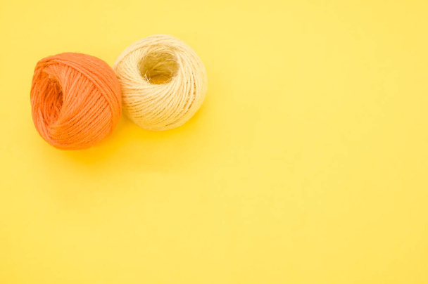 The yarn balls for knitting isolated on yellow background - Фото, зображення