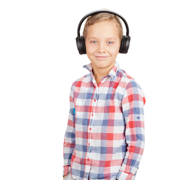 Young boy listening to music with headphones. Isolated on white background - Foto, afbeelding