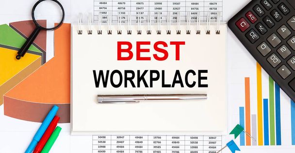 Notepad on office desk with charts with text BEST WORKPLACE - Photo, Image