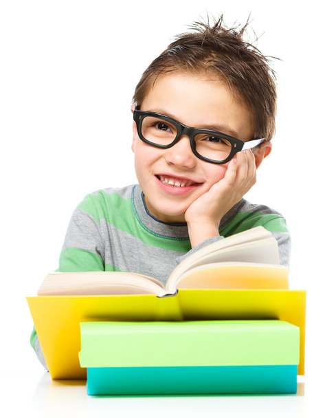 Little boy is reading a book - Foto, afbeelding
