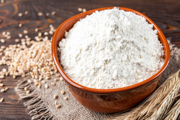 Wheat flour on wooden background. - Photo, Image