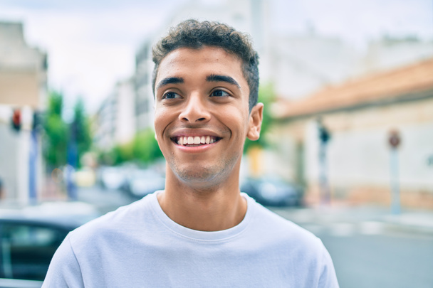 Young latin man smiling happy walking at the city. - Photo, Image