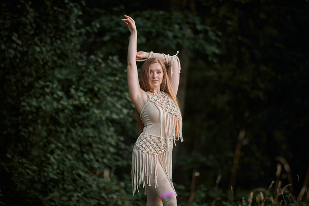 Portrait of a beautiful graceful blonde woman dancing. In the woods in summer. - Foto, Imagen