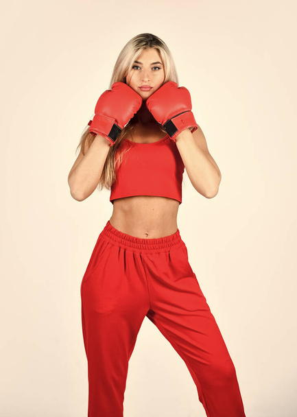 Happy and sporty. Sports training. best motivation for her. active lifestyle. girl doing boxing workout in gym. wear gloves to hitting. woman actively train in gym. do exercise in boxing gloves - Photo, image