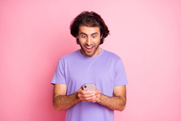Photo of addicted cheerful person shocked post make repost share purple outfit isolated on pink color background - Fotografie, Obrázek