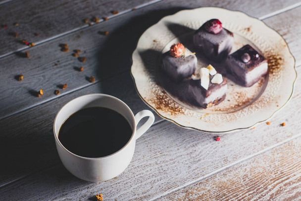 Still life of chocolate cake dessert and cup of coffee on wooden table - Photo, image
