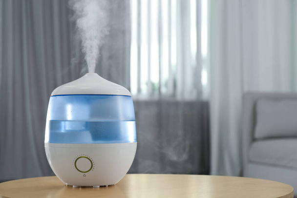 Modern air humidifier on table indoors. Space for text - Photo, Image