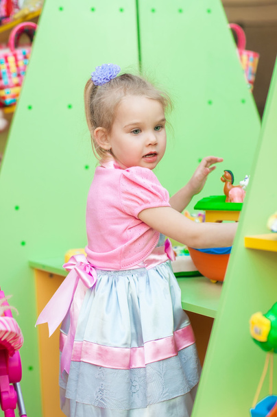 Little girl with toys in the playroom - Foto, Imagen