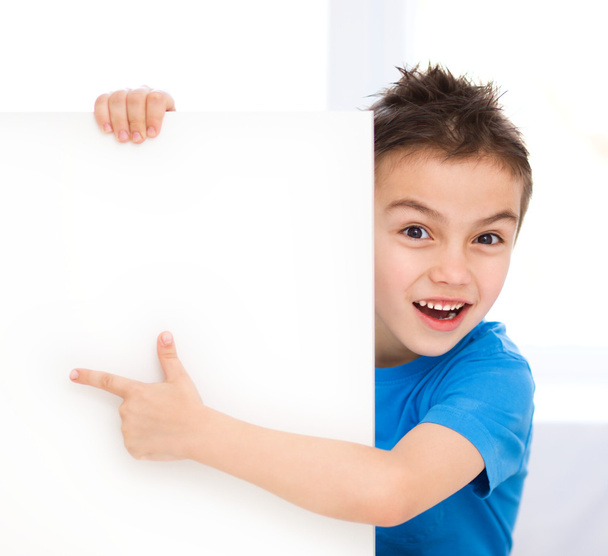 Cute boy is holding blank banner - Photo, image