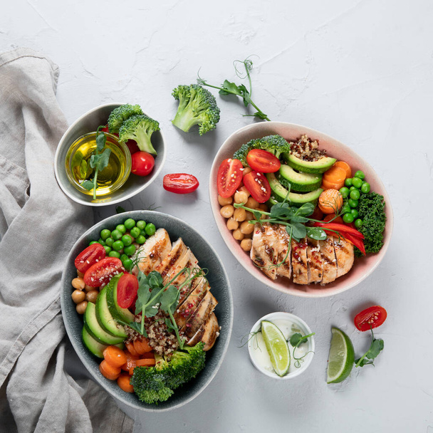 Healthy chicken Buddha bowl with vegetables, chickpea and quinoa. Grilled chicken salad. Clean and balanced healthy food concept. Top view, copy space - Fotoğraf, Görsel