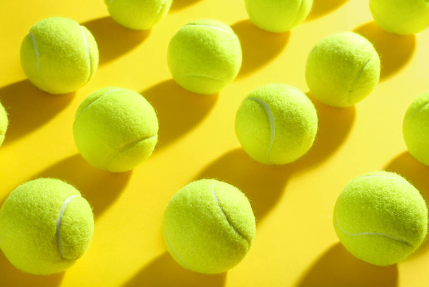 Tennis balls on yellow background. Sports equipment - Fotoğraf, Görsel