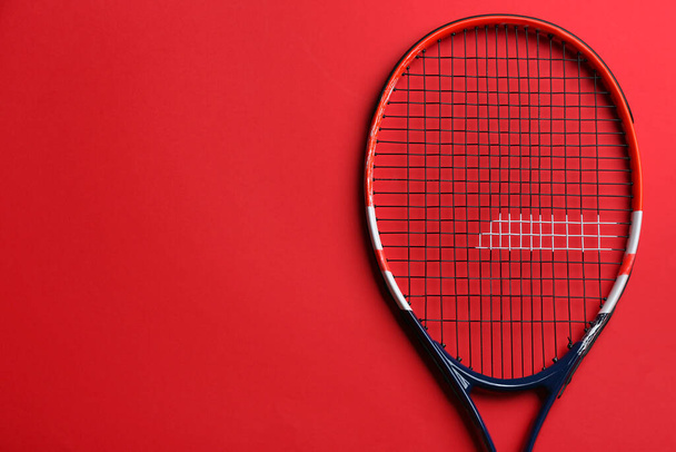 Tennis racket on red background, top view. Space for text - Valokuva, kuva
