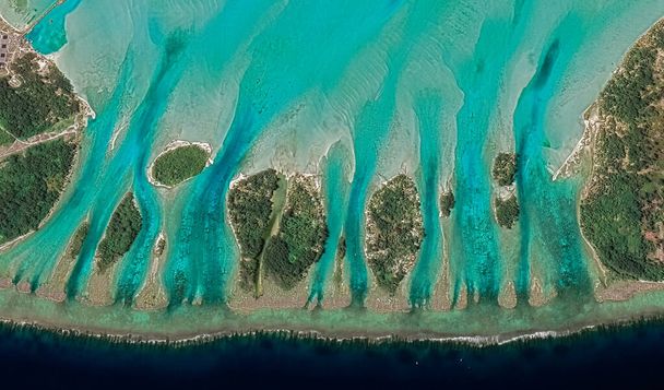 Landscape of the coast of the resort island of Bora Bora from a bird's eye view with turquoise water and sandy beaches - 写真・画像