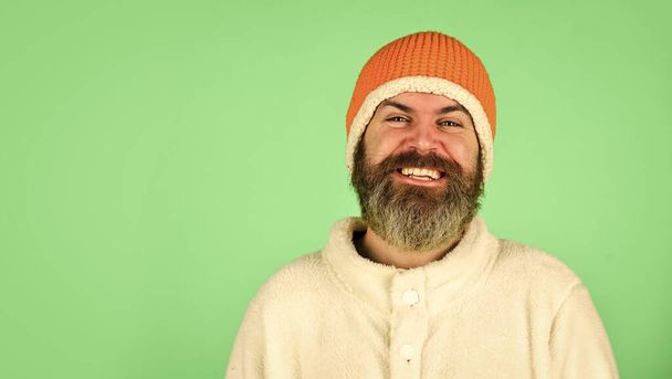 Lets celebrate. cold and flu. Portrait of brutal man in fleece sweatshirt. Handsome male model wearing warm hat. casual man in winter hat and warm clothes. happy hipster wear warm hat. copy space - Photo, Image
