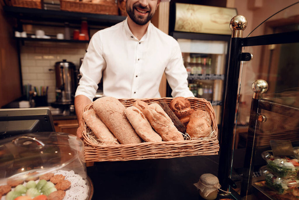 Young Bearded Man in Apron Standing in Bakery. - Фото, изображение