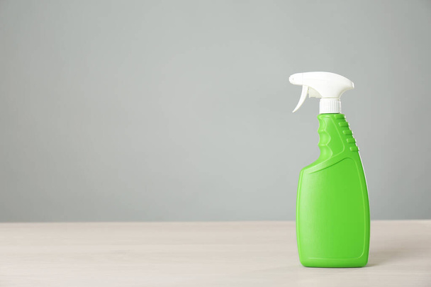Bottle of cleaning product on light table. Space for text - Foto, Bild