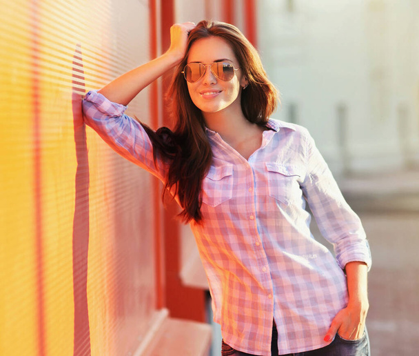 Summer portrait of beautiful young brunette woman in the city - Fotó, kép