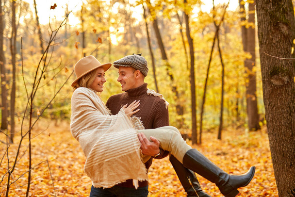 lovely couple spend time at sunny autumn day in forest - Fotoğraf, Görsel
