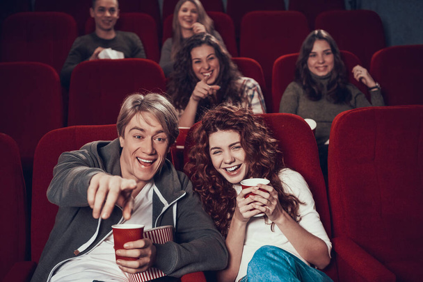 People sit in the cinema and watch a funny comedy. - Fotó, kép