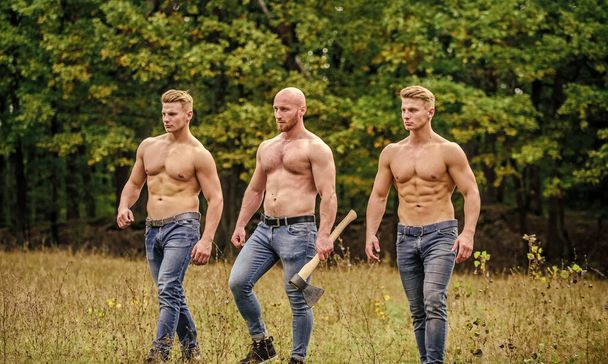 Balance your life. athletic man use ax. brutal and strong male. sexy guys six packs and biceps. protein or steroids. bodybuilding concept. relax after work in the forest. three muscular men with axe - Foto, afbeelding