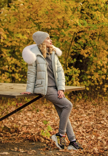 Clothes for rest. Girl relaxing in nature wearing knitwear suit and jacket. Model knitwear clothes leaves background. Warm knitwear. Feel practicality and comfort. Woman enjoy autumn season in park - Foto, Imagem