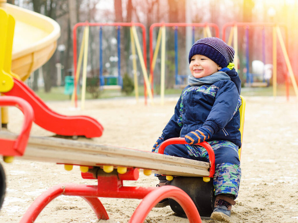 smiling little boy on the seesaw - Photo, Image