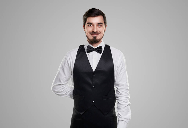 Confident smiling waiter in elegant outfit - Foto, imagen