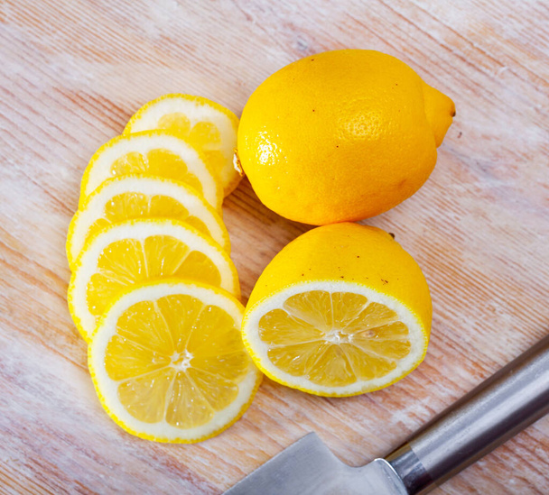 Sliced lemon on wooden table - Photo, image