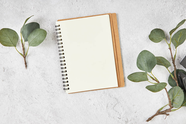 White blank note paper and big green tropical leaves on background. Flat lay. Top view. Copy space. - Fotoğraf, Görsel